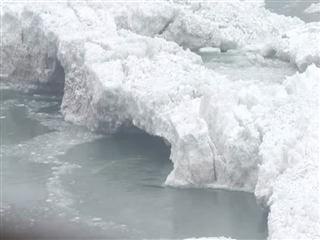 Water still cascades over nearly frozen Niagara Falls