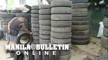 Workers in Davao City regroove and repaint discarded tires for reselling