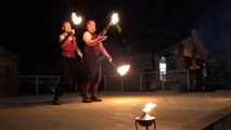 Brothers Juggle Lighted Sticks During Fire Performance At Show