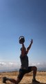 Fitness Professional Swings And Balances Heavy Kettlebell on His Hand
