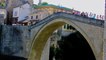 People passing over famous Old Bridge in Mostar.