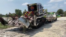 Loading a tractor on a trailer in Thailand