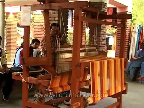 Weaver working a traditional loom - Indian handicrafts