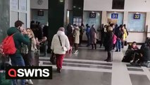 Residents in Kyiv queue to buy tickets at the city's central train station as Russian troops close on the Ukrainian capital