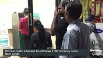 People line-up to withdraw 100 rupee notes at ATMs