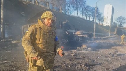 Ukrainian soldiers inspecting wreckage from overnight fighting in Kyiv