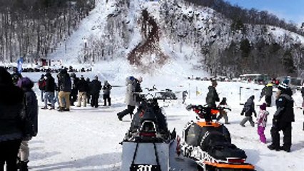 Hill Climber Trying to Stop Tumbling Snowmobile Gets Beat Up
