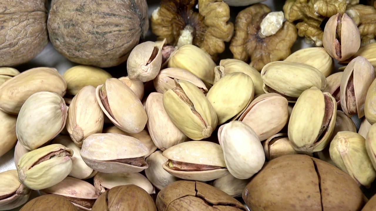 Moving past the camera portion of dried nuts - hazelnuts, peanuts, cashews, almonds, walnuts, pistachios, pecans