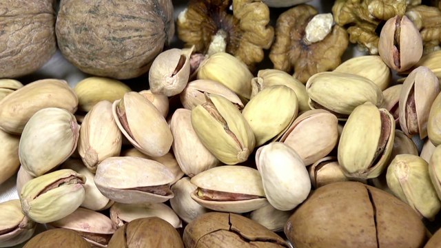 Moving past the camera portion of dried nuts - hazelnuts, peanuts, cashews, almonds, walnuts, pistachios, pecans