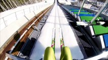 Why ski jumpers hold their skis in a V_2