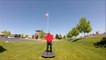 Guy Bounce Juggles Multiple Balls in Front of Flag of United States