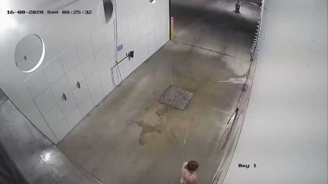 Bizarre footage shows man showering naked in a car wash