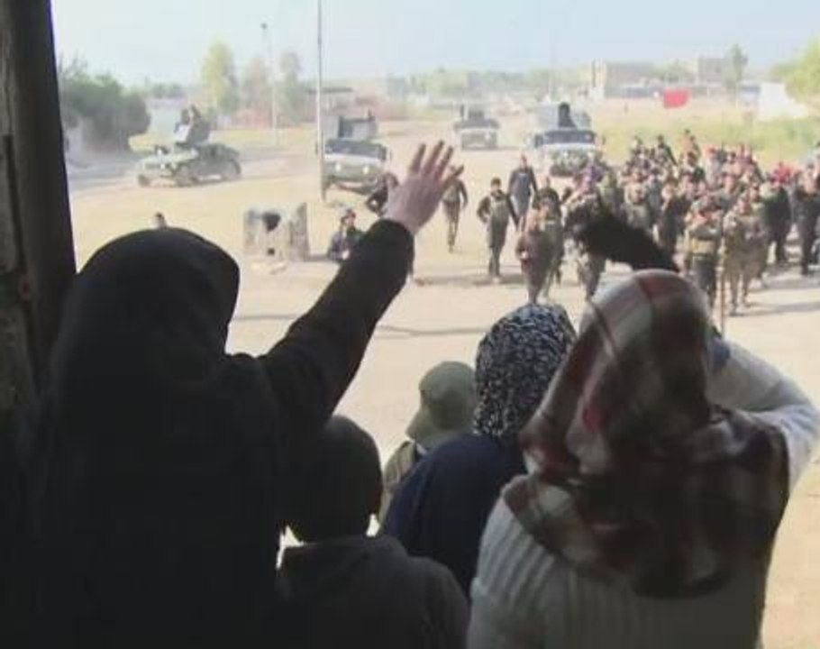 Iraqis in liberated Mosul district wave white f...