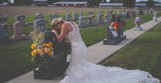 Braut kniet am Tag ihrer Hochzeit vorm Grabstein ihres Bräutigams