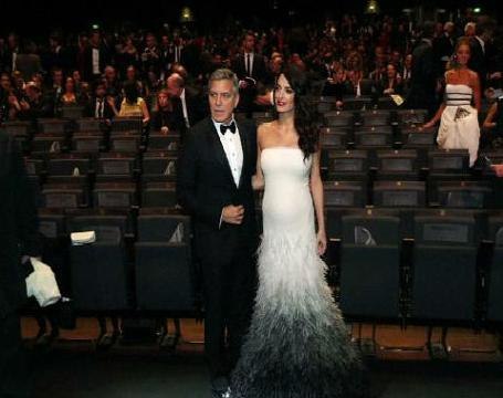 Amal Clooney shows off her baby bump at Cesar Awards