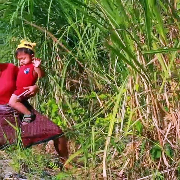 Wild Women - Mother and child Help baby Duck by river