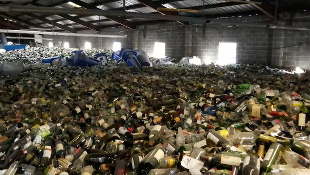 Piles of glass from Mardi Gras parties transformed into sand
