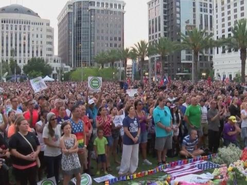 Candles, tears and song at Orlando vigil for massacre victims