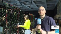 Volunteers make camouflage nets for Ukrainian army in Lviv museum