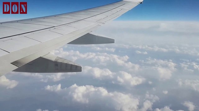 View From An Airplane Window Flying Above The Clouds