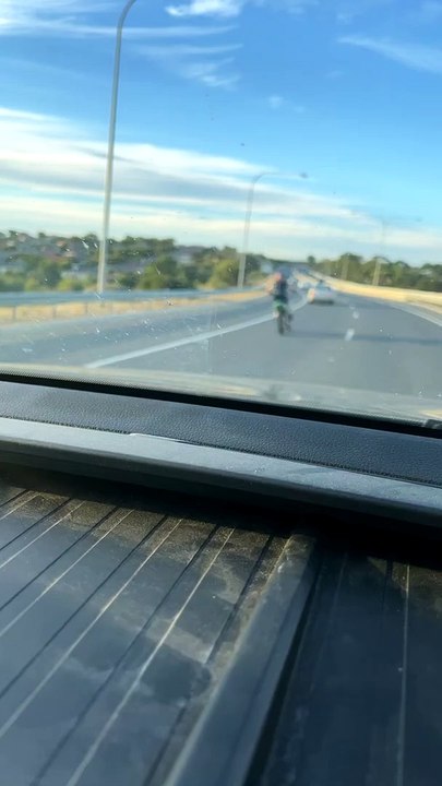 Young Motorcyclist Does High Speed Stunts