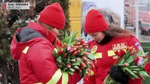 Romanians greet refugees with Women's Day flowers