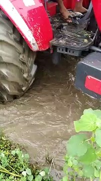 Mahindra Arjun Novo 605 with rotavator in water field