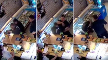 En Russie, un agent de sécurité maîtrise un homme armé d'un pistolet braquant une vendeuse