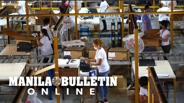Comelec employees check the machines to be used in the upcoming May 2022 Elections