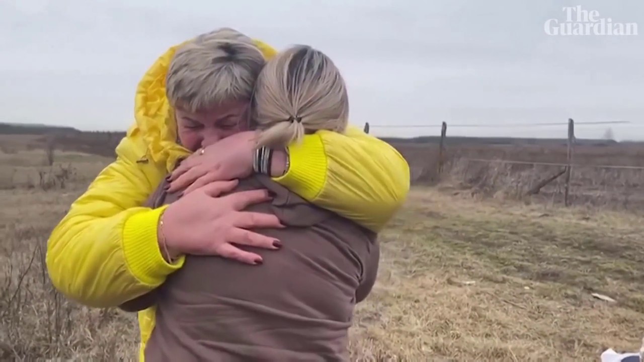 Ukrainian mother hugs her children brought to safety by a stranger