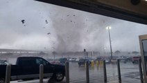People sprint for a Walmart's doors as tornado rips through the parking lot