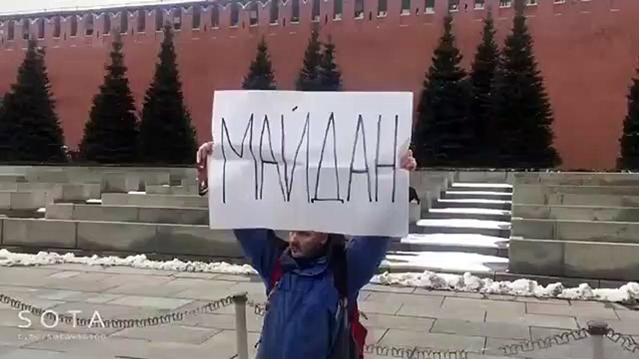 Russian protester was arrested for holding a protest sign  saying " Maidan"