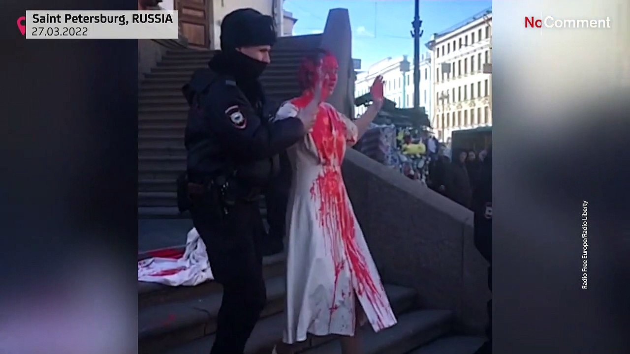 Russian artist doused in fake blood protests against invasion of Ukraine