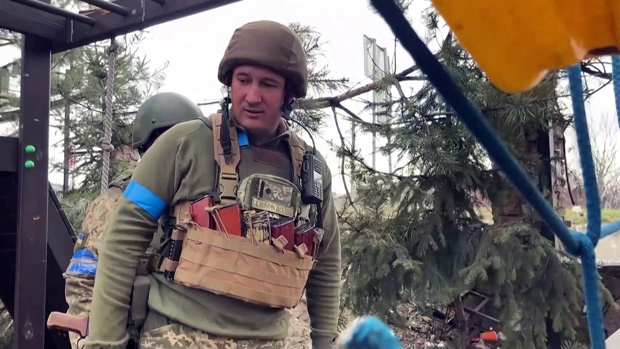 Ukrainian soldiers patrol village near Kyiv they have retaken as Russians claim they are withdrawing from capital