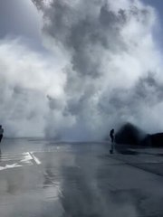 Waves smash into jogger at Nobbys