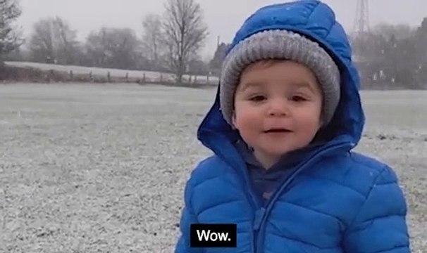 'Wow!' One-year-old boy reacts with awe as he stands under falling snow for the first time in heartwarming video