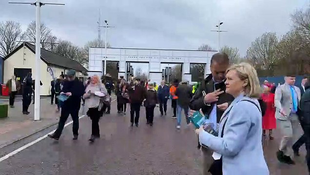 The first Grand National spectators head through the gates at Aintree Racecourse