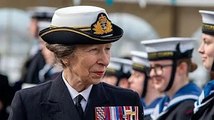 Princess Anne smiles widely as she displays her medals during royal visit