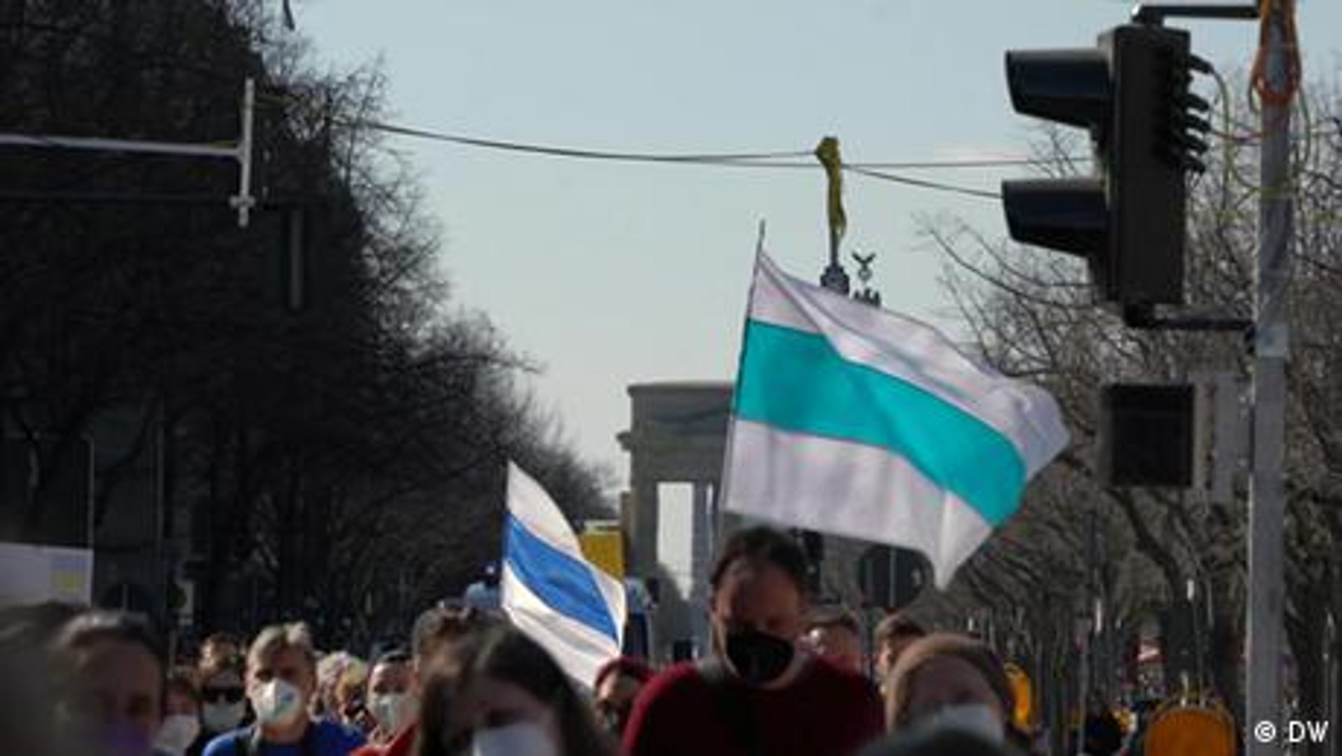 ⁣Russian anti-war protesters fly modified Russian flag