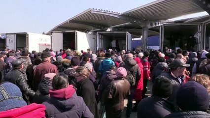 Drone footage shows Mariupol's remaining residents receiving aid from Russia in the beseiged city