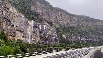 ILLAWARRA MERCURY: The rain pours down the escarpment near Sea Cliff Bridge, April 7, 2022