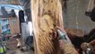 Man Carves Owl on Back of Wooden Chair Planter With Power Tools