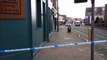 A Wigan road remains closed after a car hit a woman and two men outside a bar