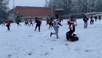 Football players have snowball fight after spring practice
