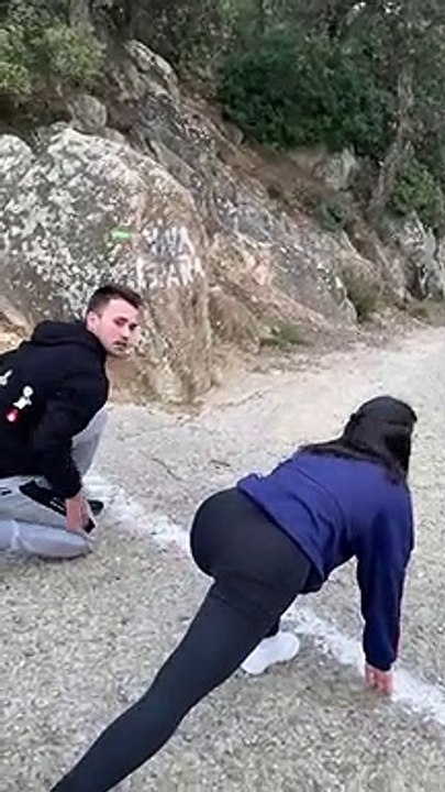Girl Running Against Friend in Mountain Race Trips Over Her Foot