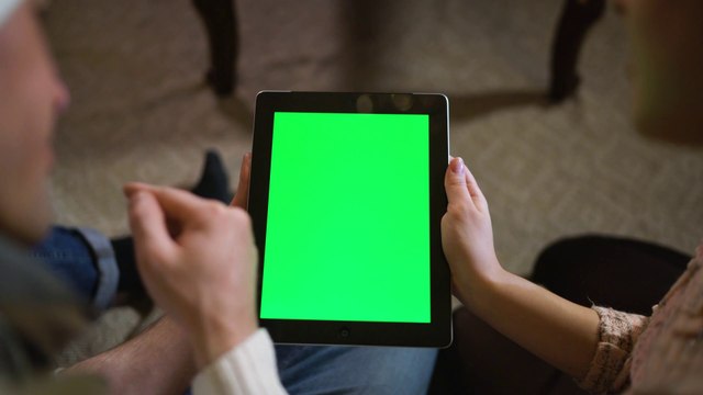 couple-watching-together-a-tablet-with-green-chroma-4602