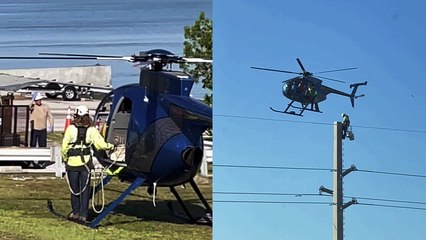 'INCREDIBLY BRAVE lineman stands on helicopter's landing skid as it takes off the ground '