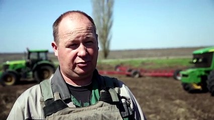 Farmers in body armor work Ukraine's frontline fields