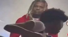 Lil Durk looks confused while he watches a fan who has passed out during his concert