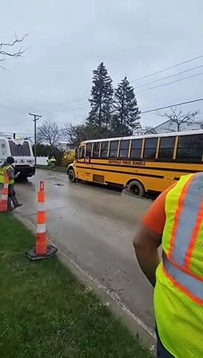 School Bus Drives on Wet Pavement